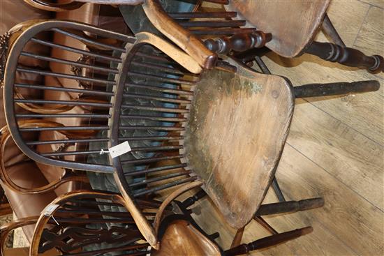 An early 19th century Windsor comb back elbow chair, with traces of original paint